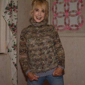 Hand knit sweater with center cable.